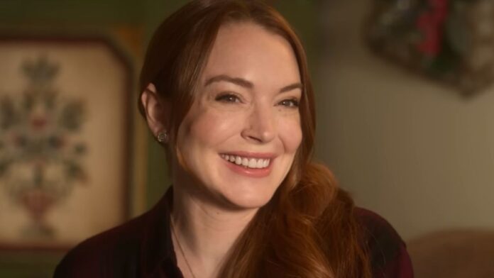 Lindsay Lohan smiling in the Falling For Christmas trailer. 